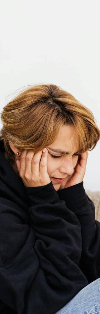 Person with hands on face.