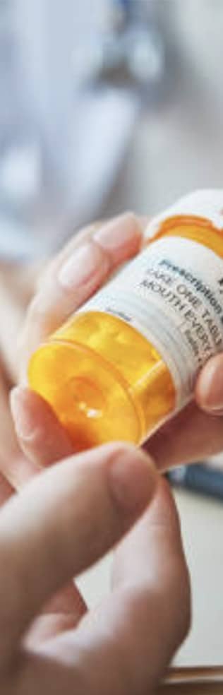 Person holding prescription medication bottle
